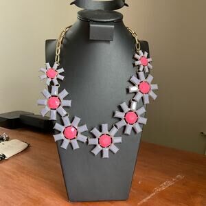 Pink and gray flower sunburst versus statement necklace